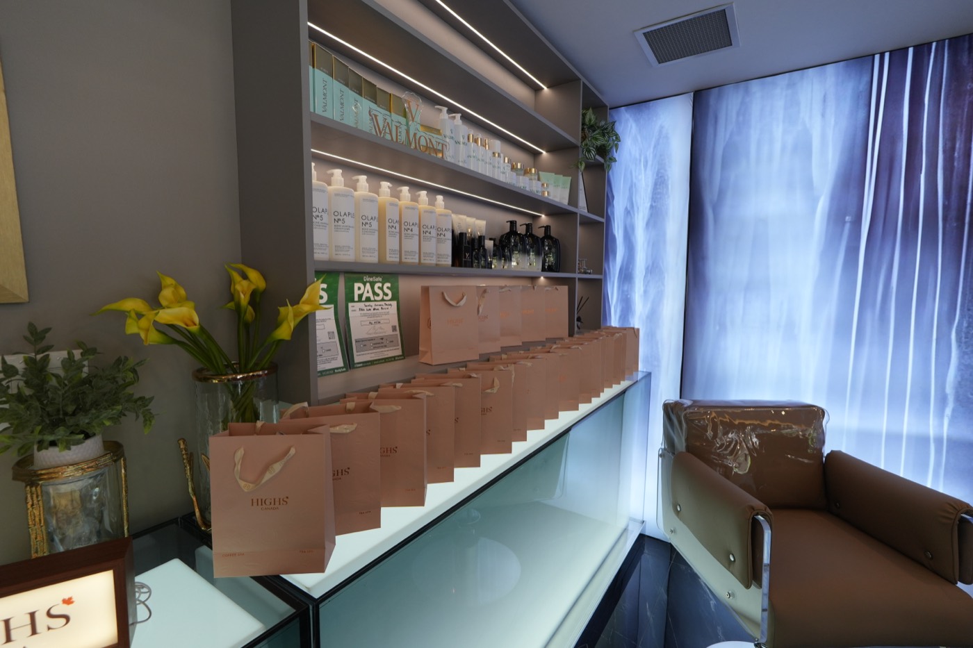 Boutique counter with calla lilies beside the backlit water wall