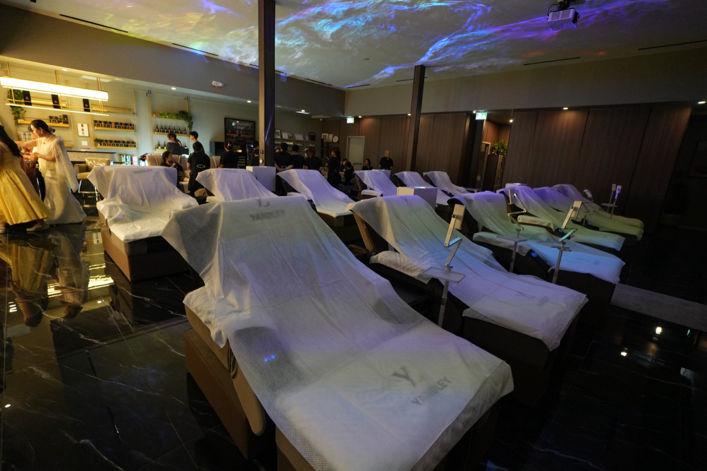 Head spa recliners draped in Yardley towels beneath the immersive ceiling